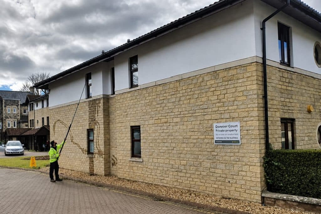 C&D Services operative using a reach and wash system at Dunster Court